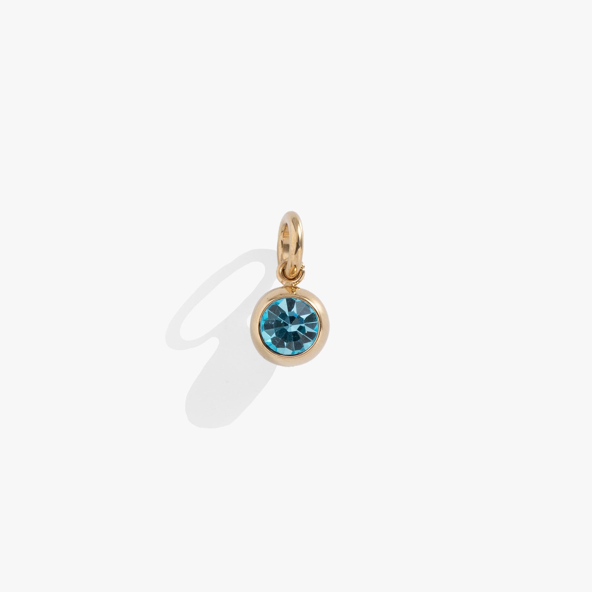 Round aquamarine crystal charm with polished gold bezel setting, perfect for charm bracelets or necklaces.