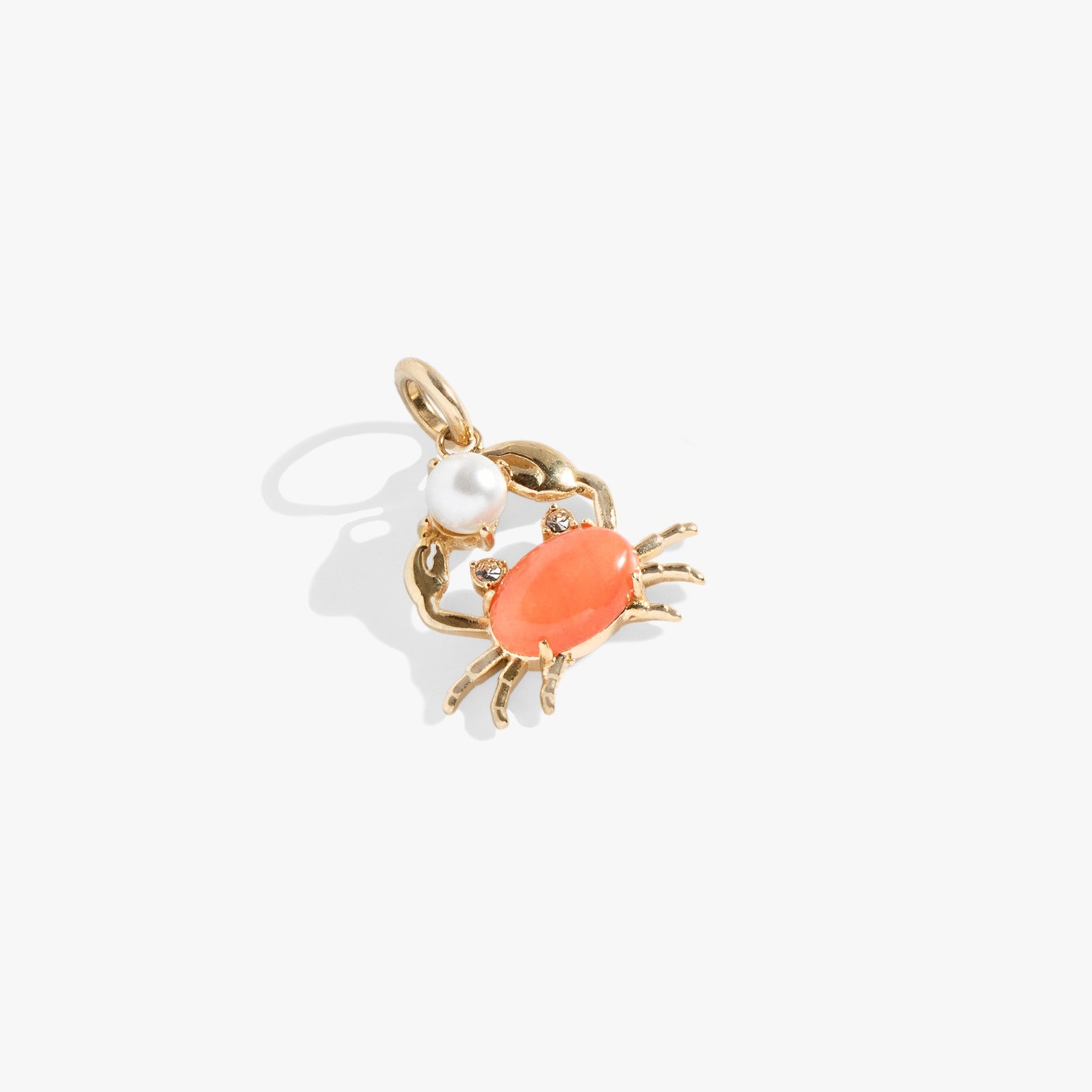 Crab charm in gold-tone stainless steel with peach jade body and glass pearl accents