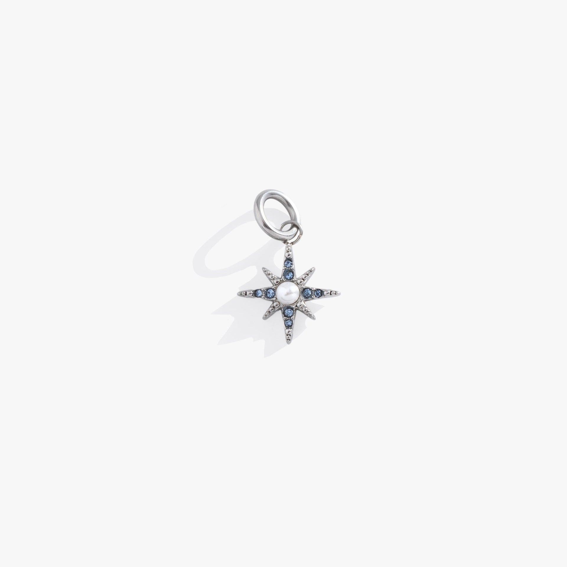 Silver-tone North Star charm with light sapphire blue crystals and pearl accents.
