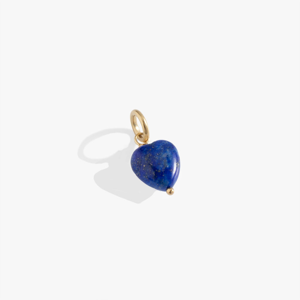 Heart-shaped genuine lapis gemstone charm with characteristic deep blue color and golden flecks.