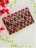 Deep maroon synthetic fabric clutch bag with a secure magnetic lock closure.