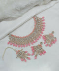 Charming pink stone work necklace set with matching tikka and earrings for a festive look