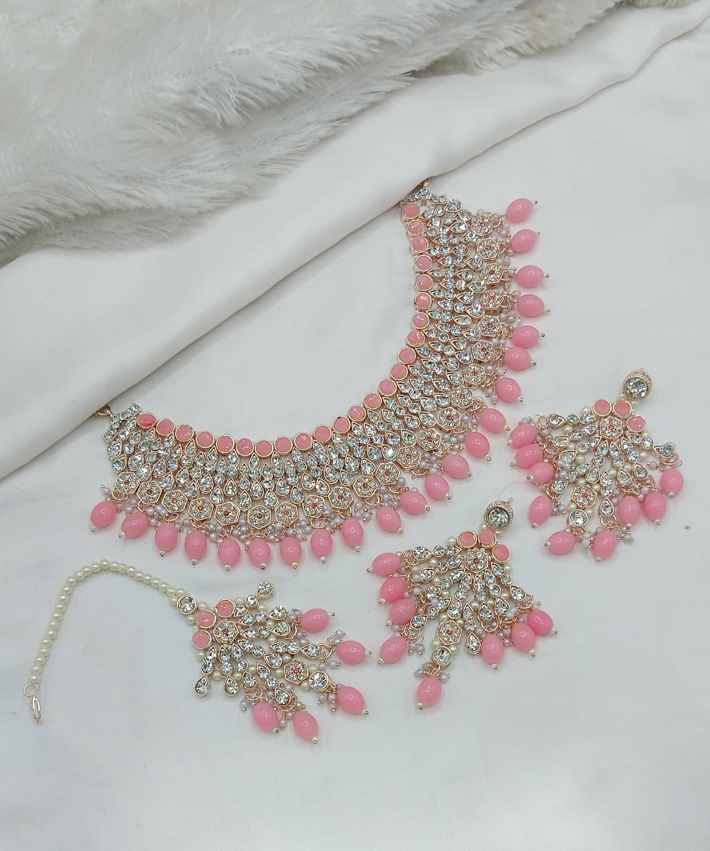 Charming pink stone work necklace set with matching tikka and earrings for a festive look