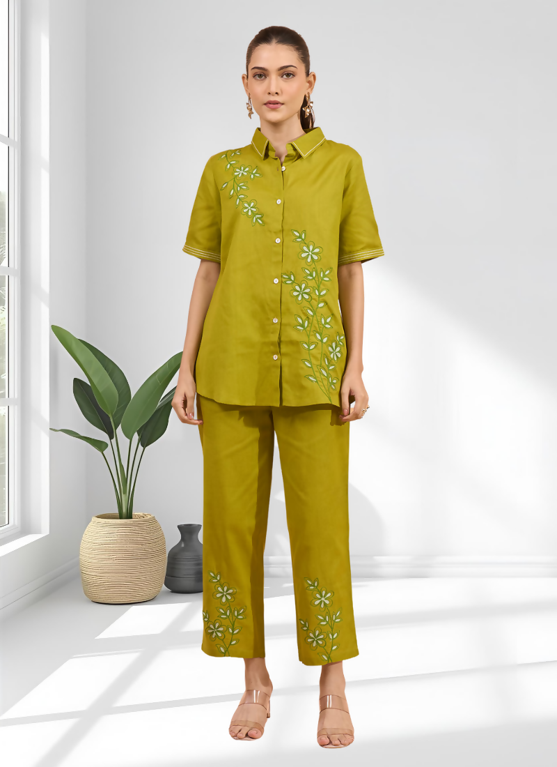 Woman wearing a green embroidered cotton linen cord set for casual party wear