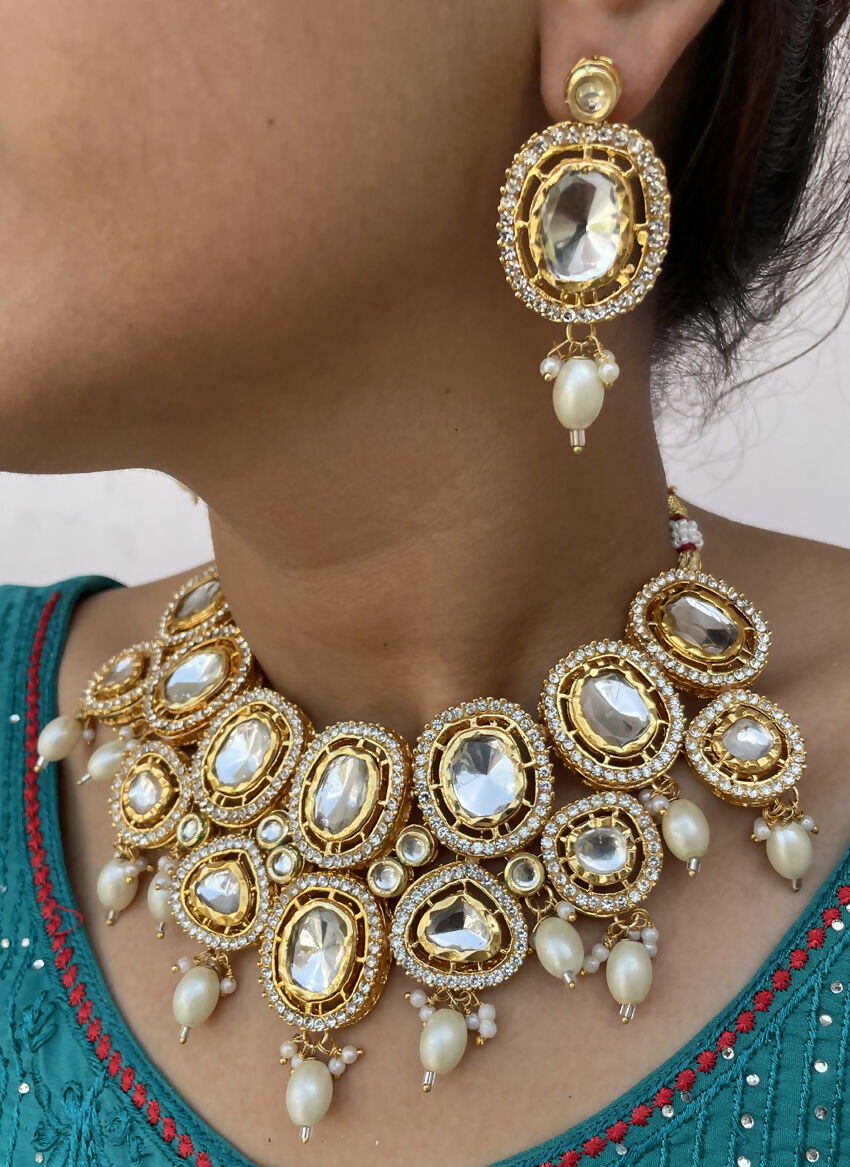Artisan gold-plated Kundan necklace set on a luxury display