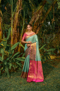 Sky blue Kanjivaram silk saree with Zari woven details and a contrasting pink blouse.