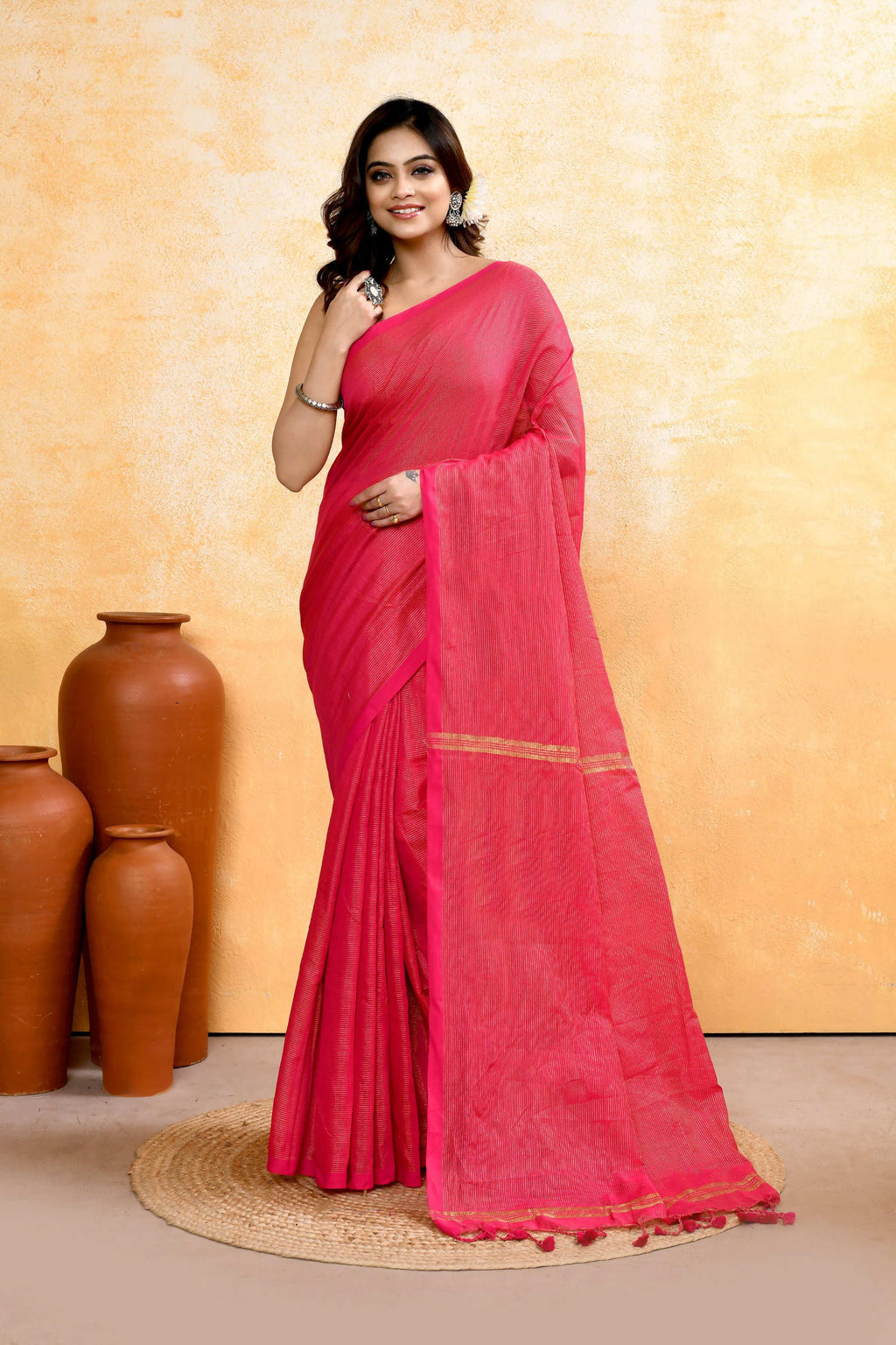 A beautiful Rani Pink handloom cotton blend saree with zari check pattern and embellishments.