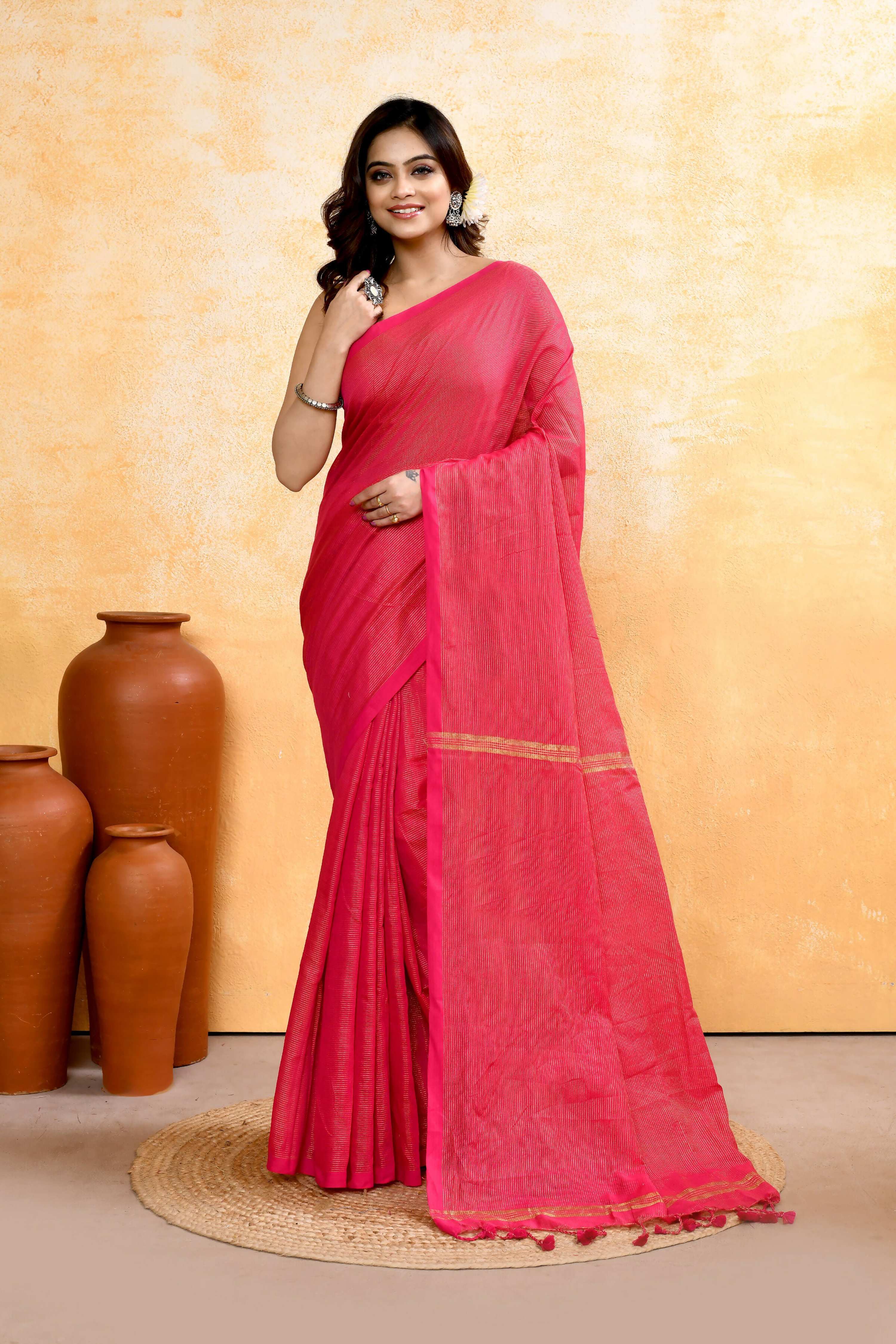 A beautiful Rani Pink handloom cotton blend saree with zari check pattern and embellishments.