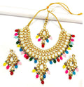 Hand-made gold-plated Kundan stone necklace and earring set on a display