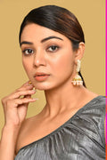 Elegant golden peach Kundan pearl earrings for women, featuring intricate craftsmanship