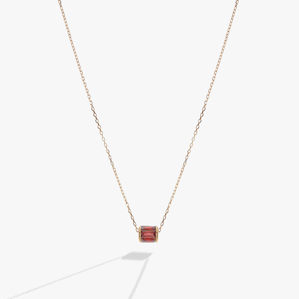 January birthstone necklace featuring a barrel-shaped scarlet crystal in a 14K gold setting
