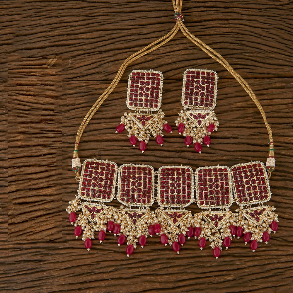 Exquisite golden necklace set featuring white rubies, Kundan pearls, and black Onyx stones