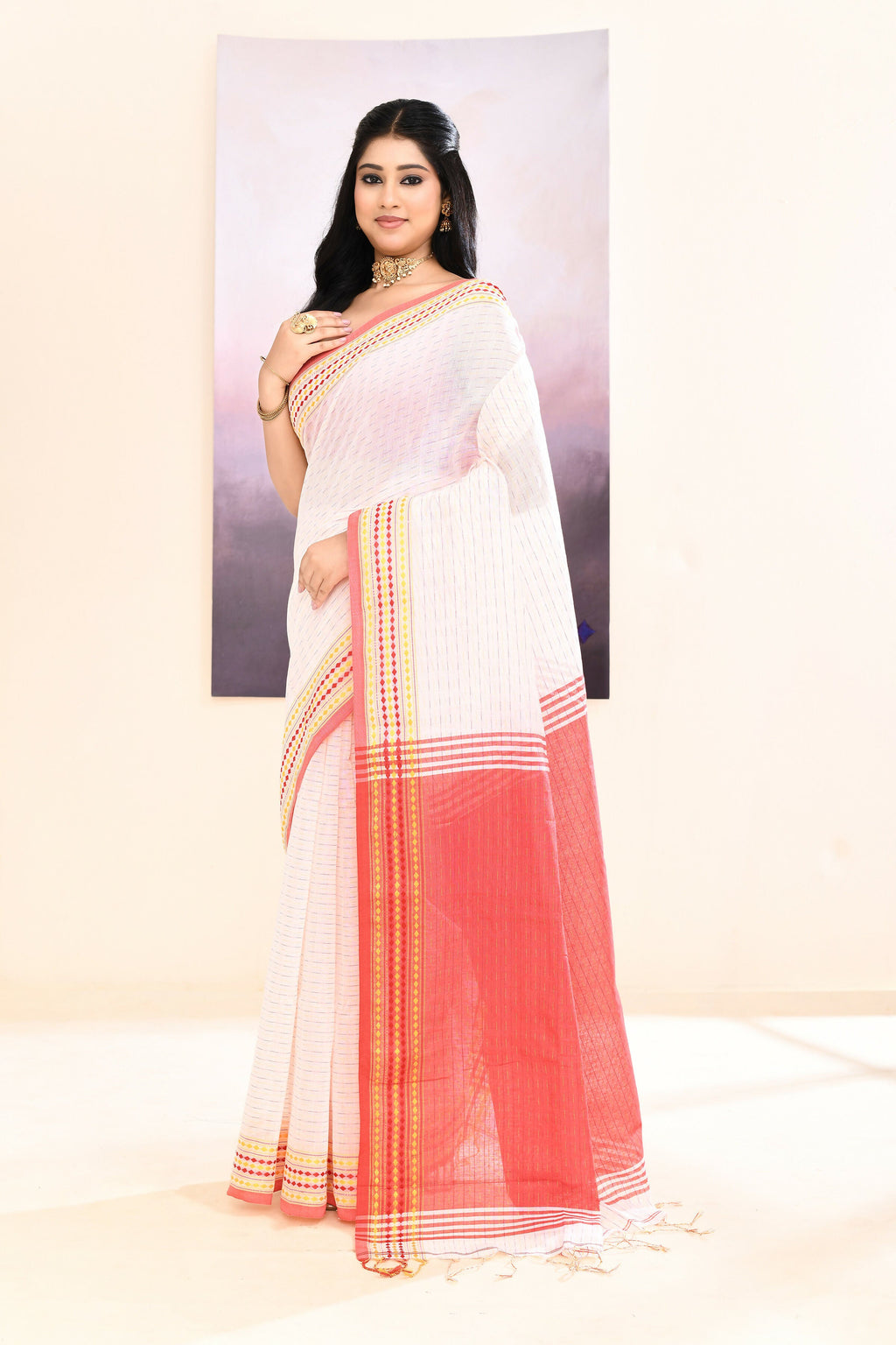 Crisp white cotton blend Jamdani saree with subtle embellishments.