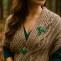 Set of two emerald green leaf brooches with silver-tone edges, styled as both pins and pendants.