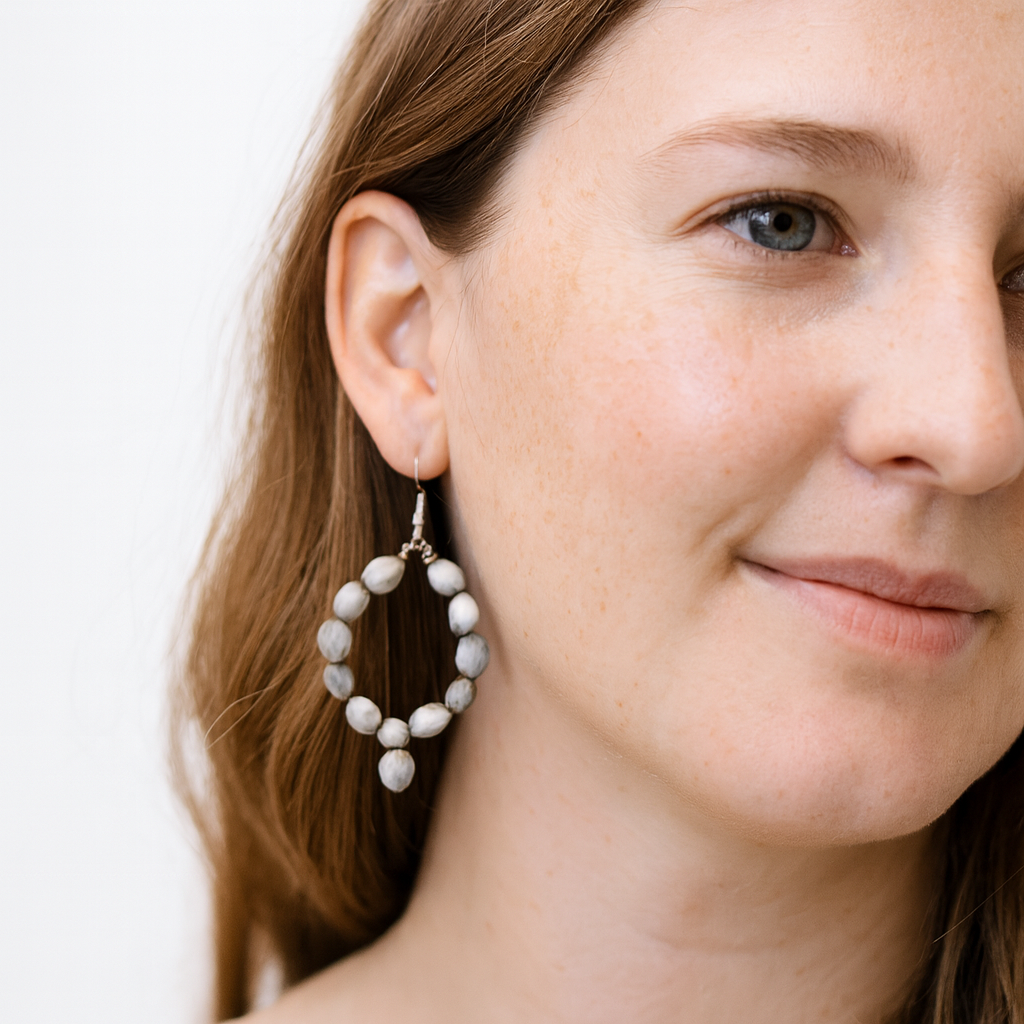 Two-inch hoop earrings made from natural, grey and white Job's Tears seeds harvested in Uganda.