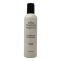 A beige bottle of John Masters Organics Citrus & Neroli conditioner on a neutral background.