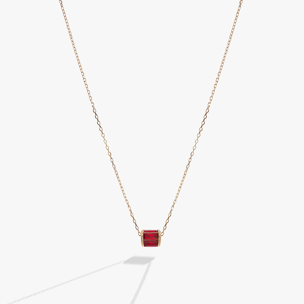 July birthstone pendant featuring a sliding barrel charm with ruby-toned baguette crystals in sterling silver.
