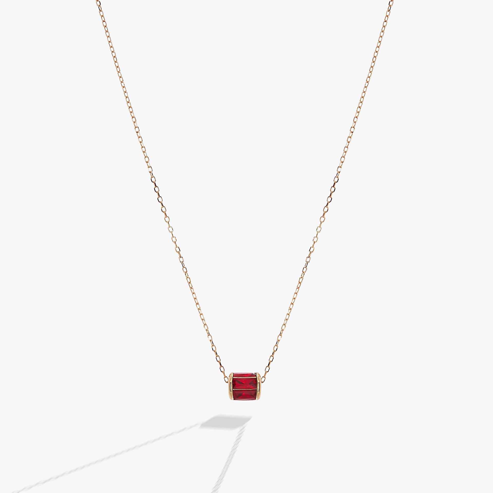 July birthstone pendant featuring a sliding barrel charm with ruby-toned baguette crystals in sterling silver.
