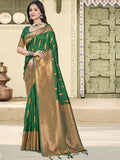 A beautiful green silk saree with a matching blouse piece displayed elegantly.