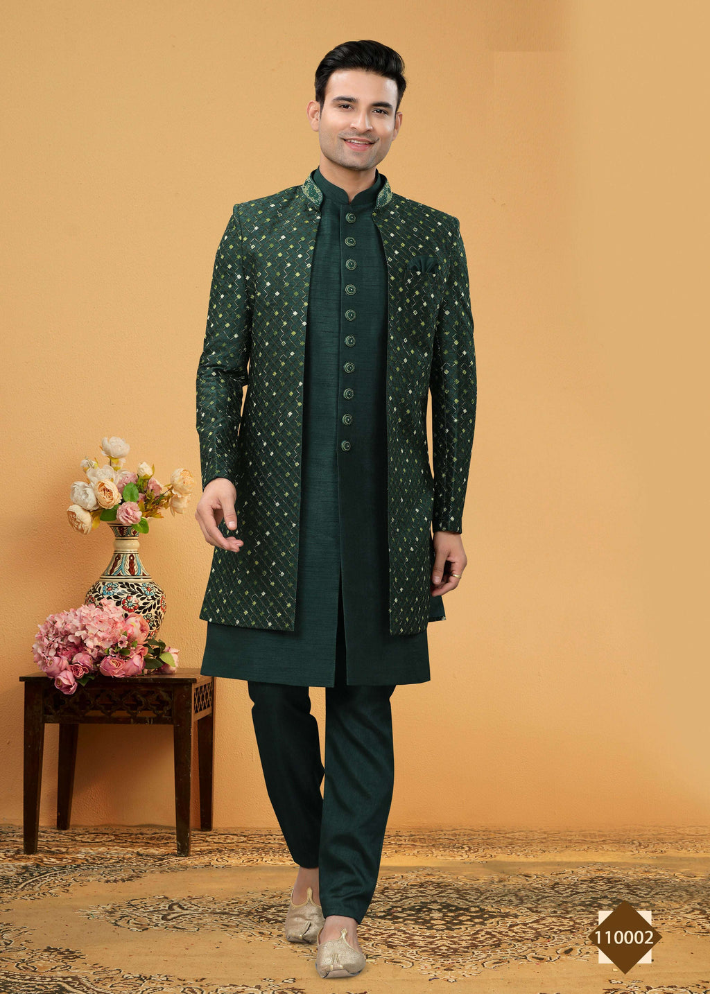 A young boy wearing a green art silk straight kurta pyjama set with a Chinese collar for a festive occasion.