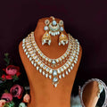 Deep double layer Kundan necklace set in green and white with brass base, elegant ethnic design