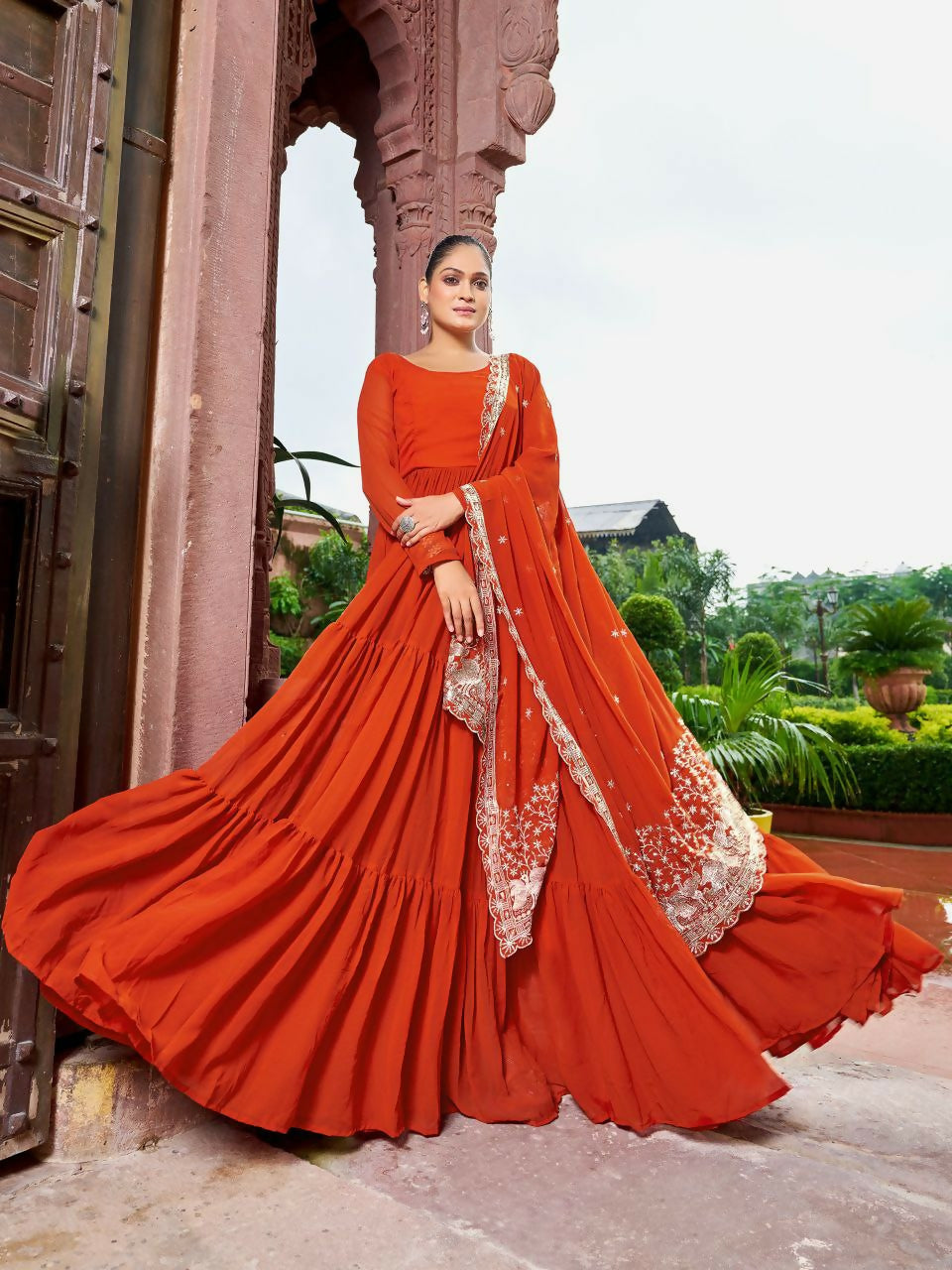 A beautiful rust-colored readymade kurta set made from georgette fabric with intricate sequin embroidery work.