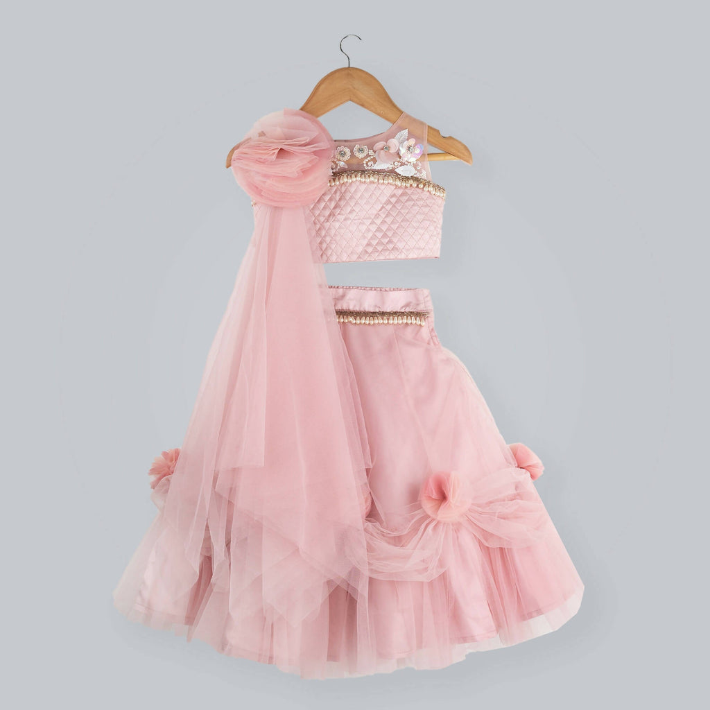 Old rose colored ghagra choli with sequence flower embellishments and pearl drop borders.