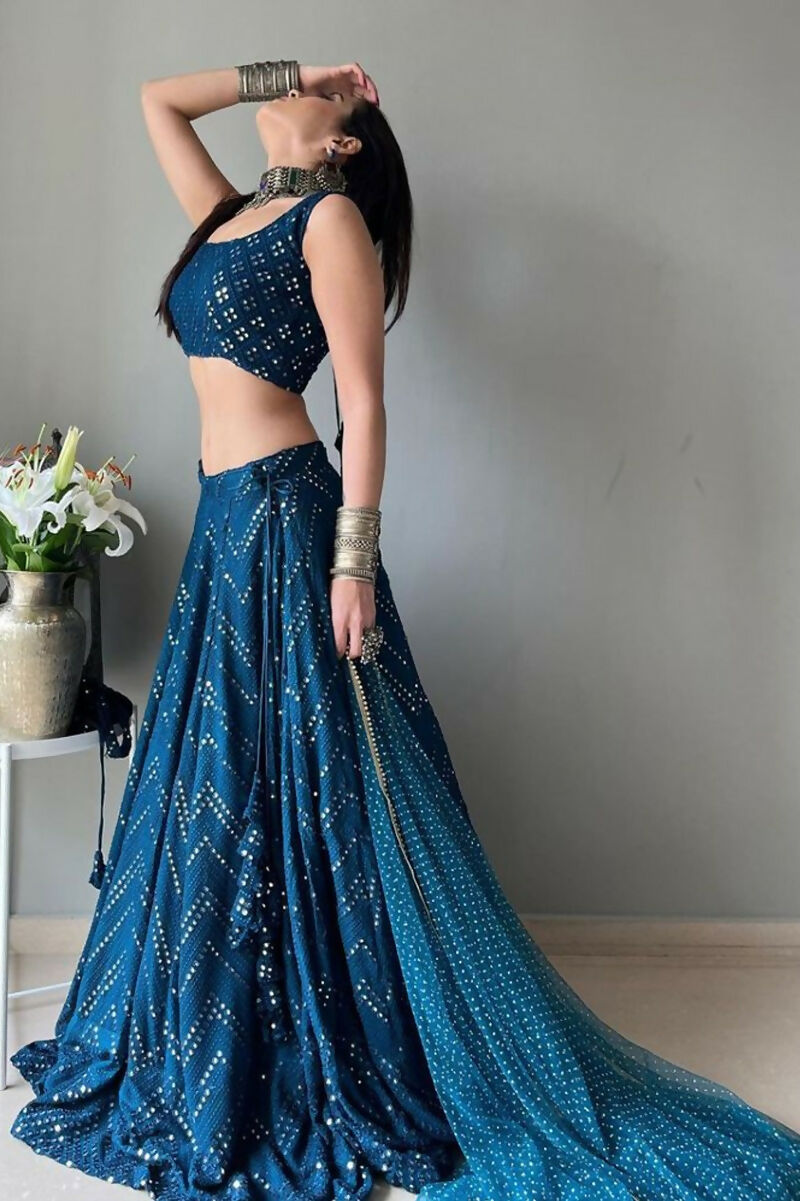 A blue faux georgette lehenga choli with intricate thread embroidery and sequin work.