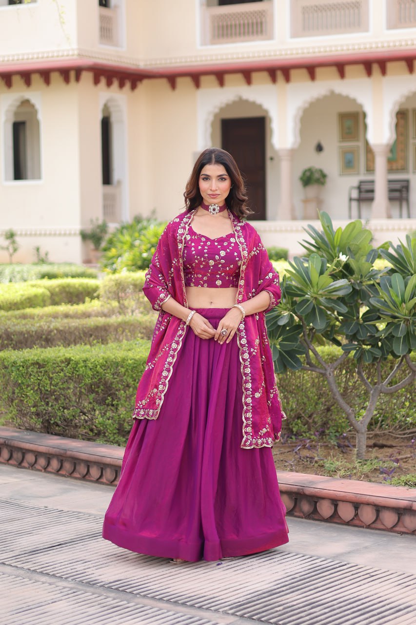 Woman wearing a purple Fendy silk lehenga choli with heavy sequin embroidery and a 3-meter flair.