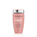Bottle of Kérastase Bain Chroma Respect sulfate-free shampoo in pink and silver bottle.