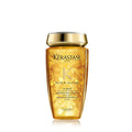 Bottle of Kérastase Elixir Ultime Sublimating Oil Infused Shampoo in a gold and amber bottle.