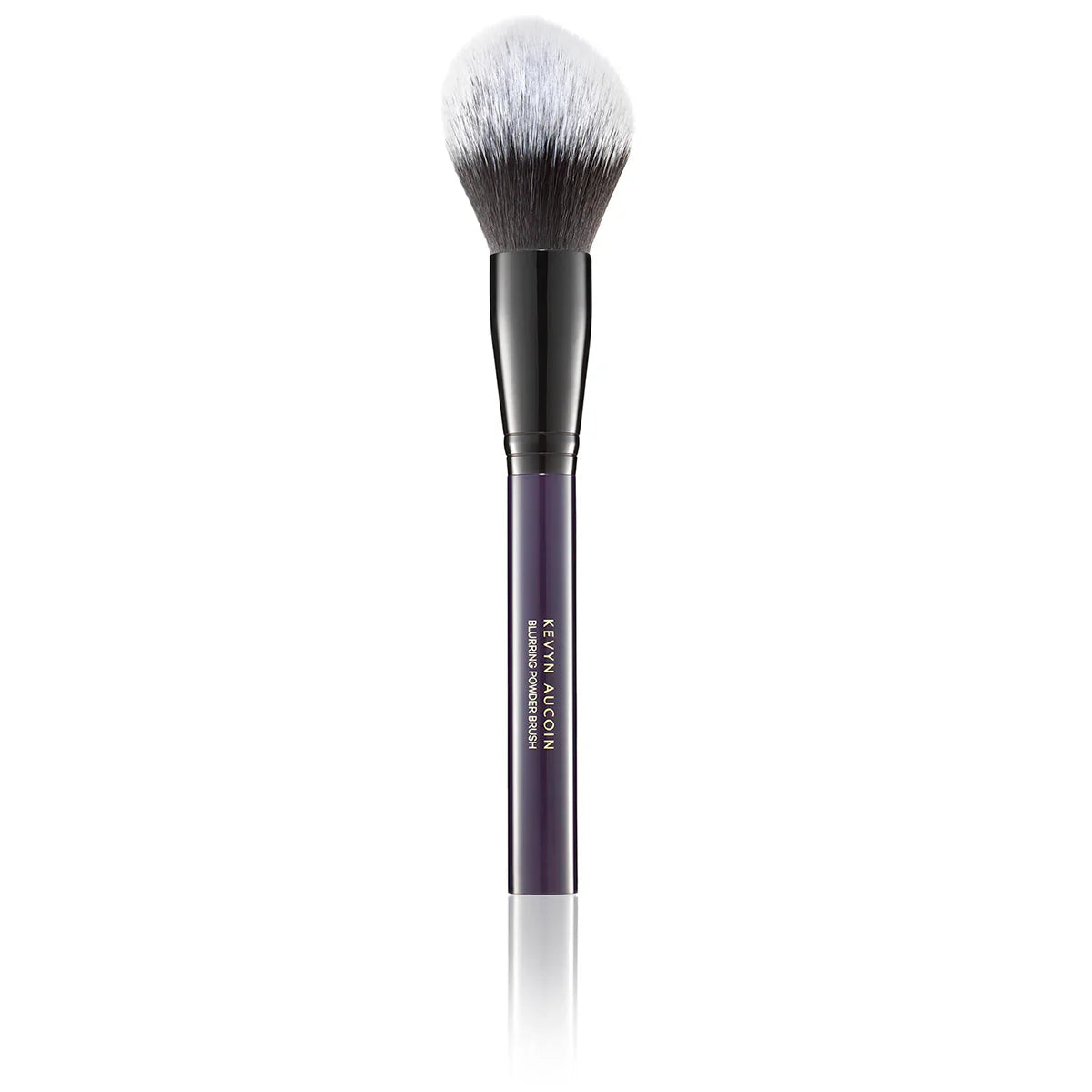 Professional dome-shaped blurring powder brush with an eggplant purple handle and dual-tone synthetic bristles.