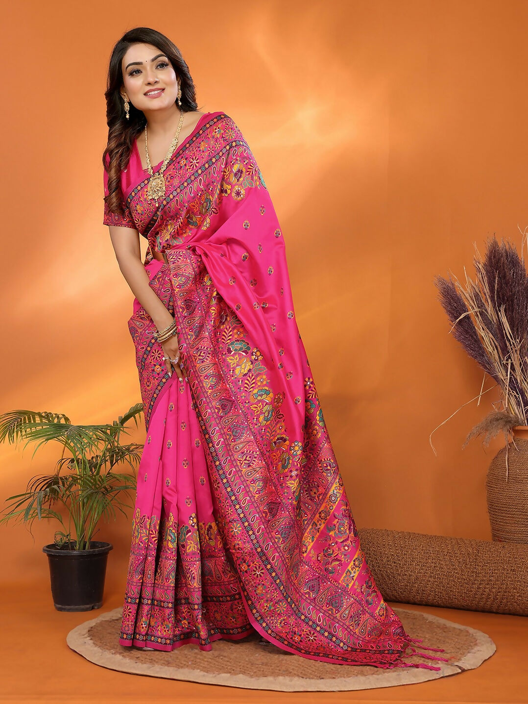Vibrant Rani Pink Meena Weaves silk blend saree with intricate weaving details.