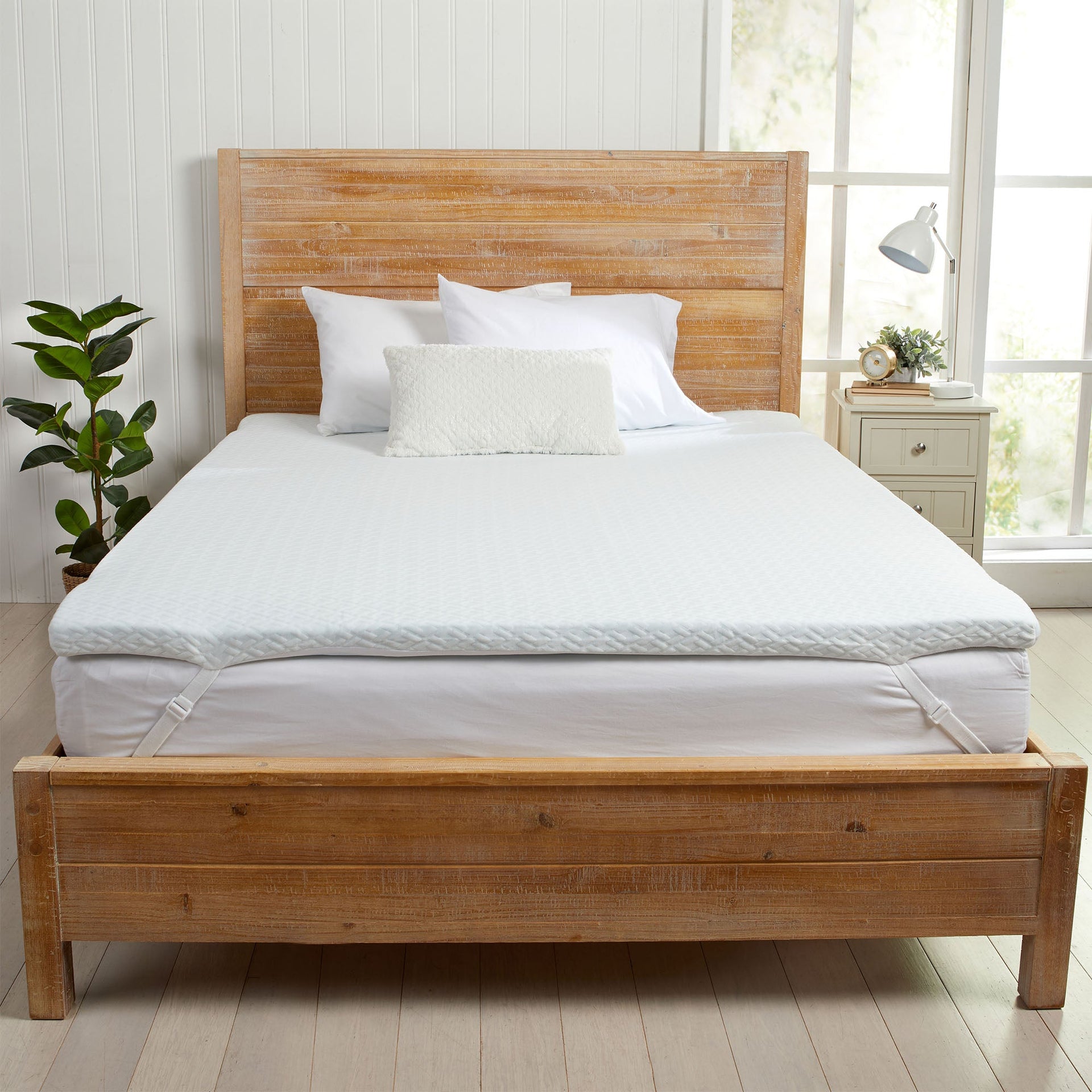 2-inch gel-infused memory foam mattress topper in white with geometric pattern and elastic corner straps.