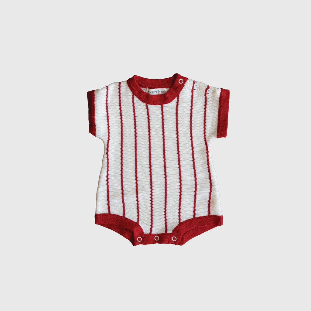 Baby wearing a preppy off-white and red pinstripe knit romper