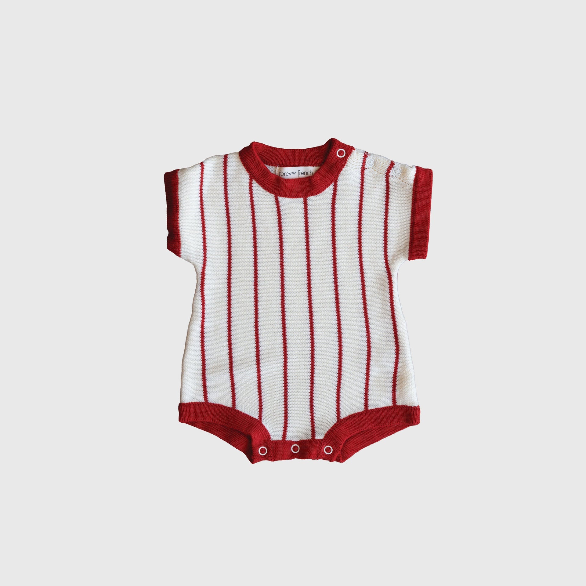 Baby wearing a preppy off-white and red pinstripe knit romper