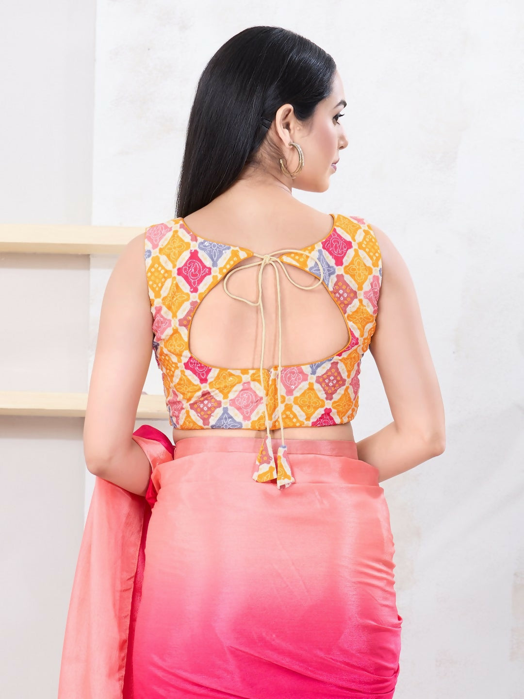 Vibrant yellow Bandhani print sleeveless blouse with boat neck.