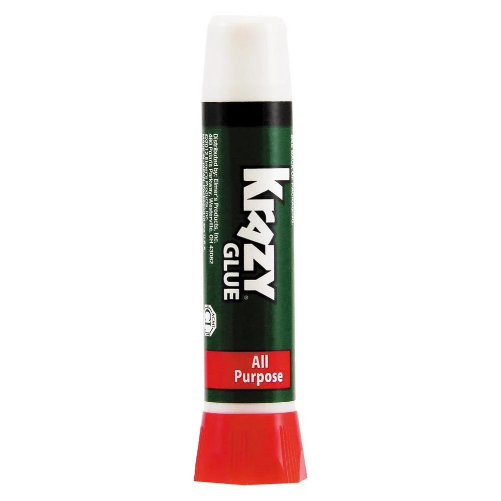 Krazy Glue 2g precision tip adhesive bottle in red, green, and white packaging.