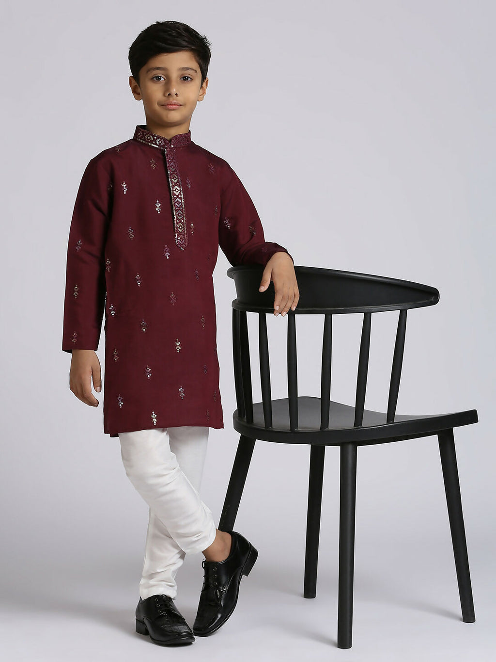 Little boy wearing a wine colored traditional kurta set with sequence embroidery