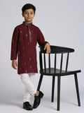 Little boy wearing a wine colored traditional kurta set with sequence embroidery