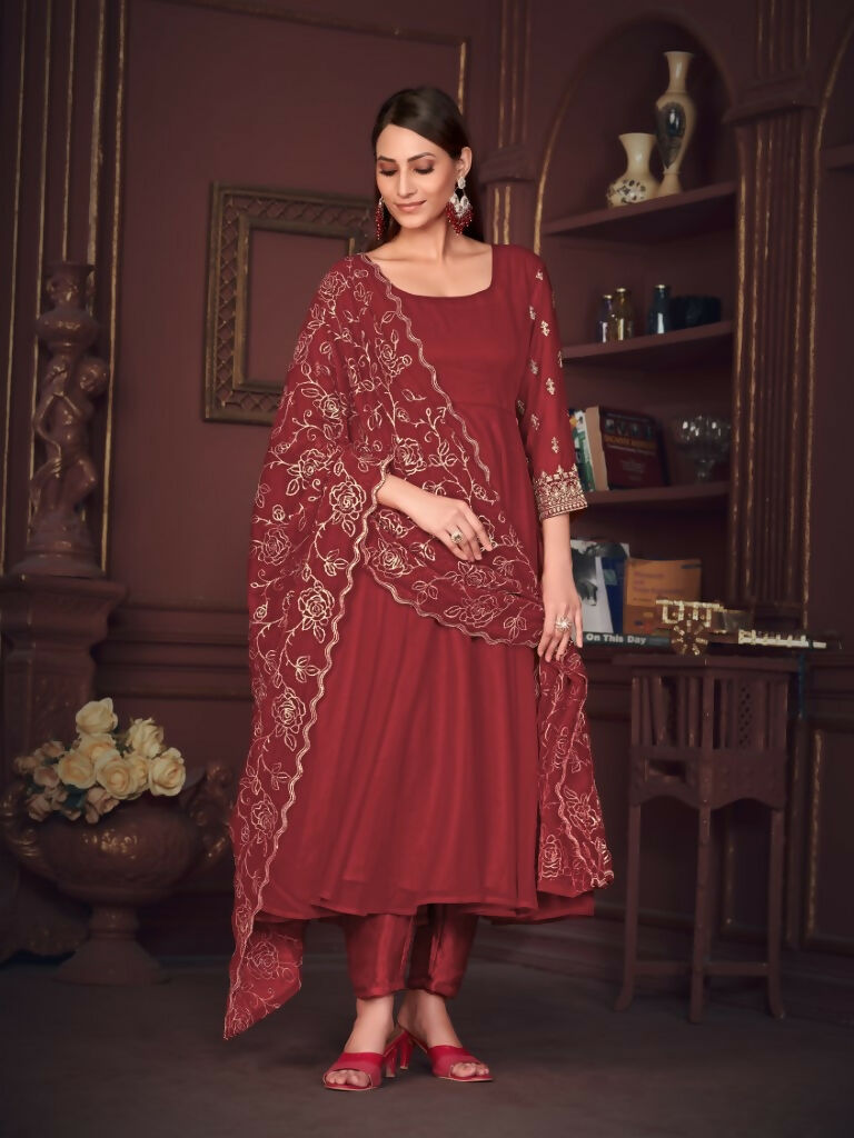 A woman wearing a maroon floor-length georgette Anarkali kurta with intricate embroidery and matching dupatta.
