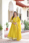 Woman wearing a vibrant yellow silk readymade kurta set with intricate sequence embroidery work