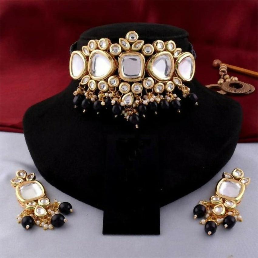 A sophisticated handcrafted black Kundan necklace set featuring gold plating and an adjustable cord.