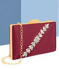 Pink satin evening clutch with a detachable metal chain strap against a neutral background