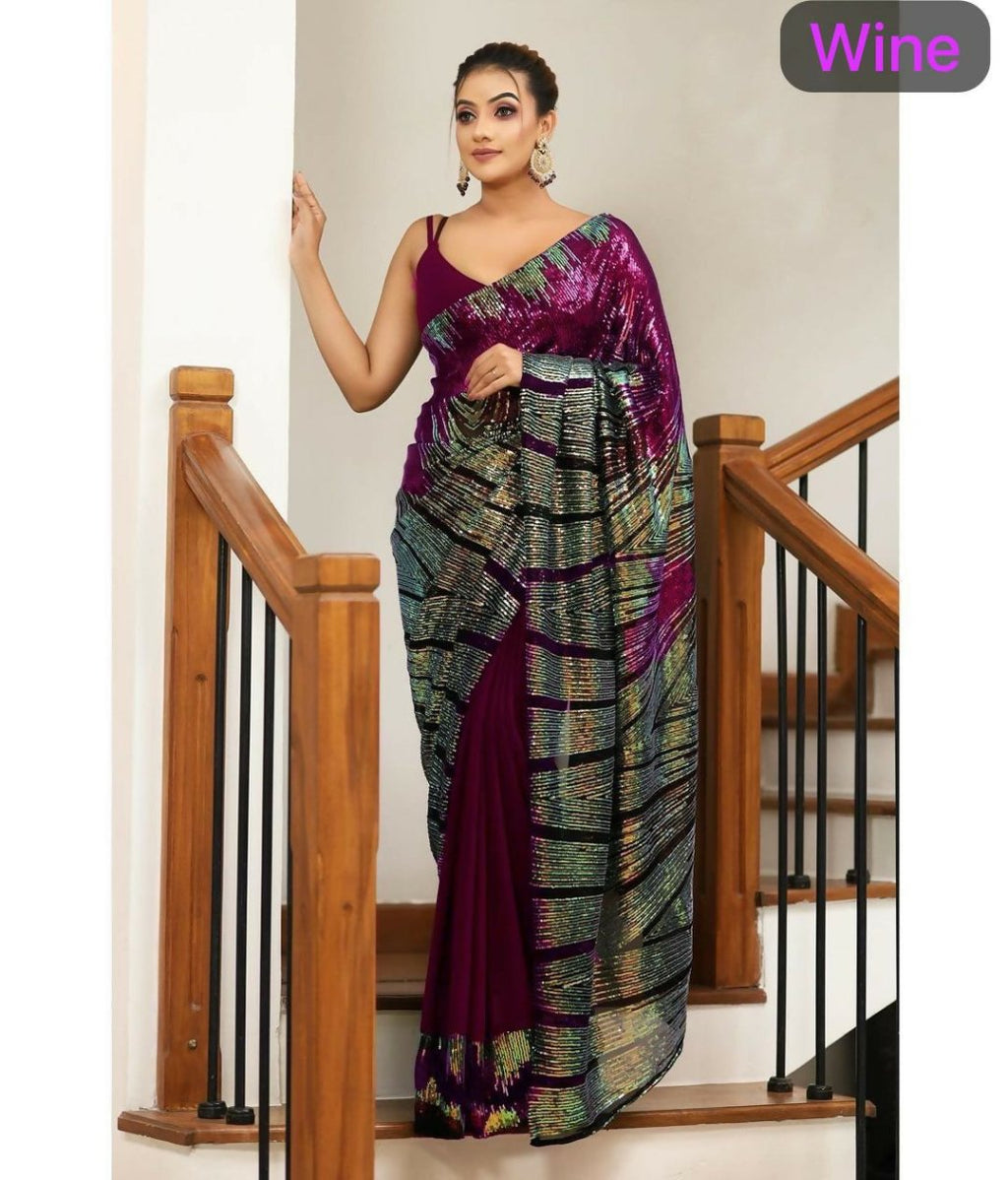 Wine colored georgette saree heavily embellished with sequins and paired with a Banglori silk blouse.