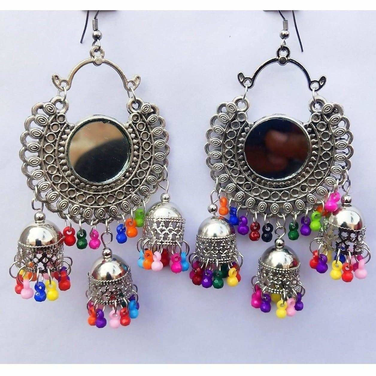 Afghani-style triple-tier silver oxidized jhumka earrings with multi-color pearl detailing.