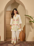 Woman wearing a cream colored Roman Silk stitched kurta with embroidery and shirt collar paired with matching pants.