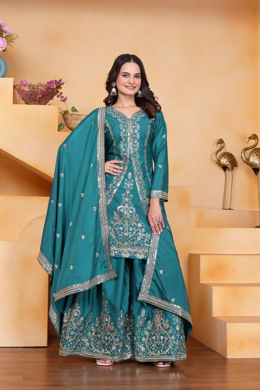 A stylish teal crepe kurti paired with matching embroidered sharara pants