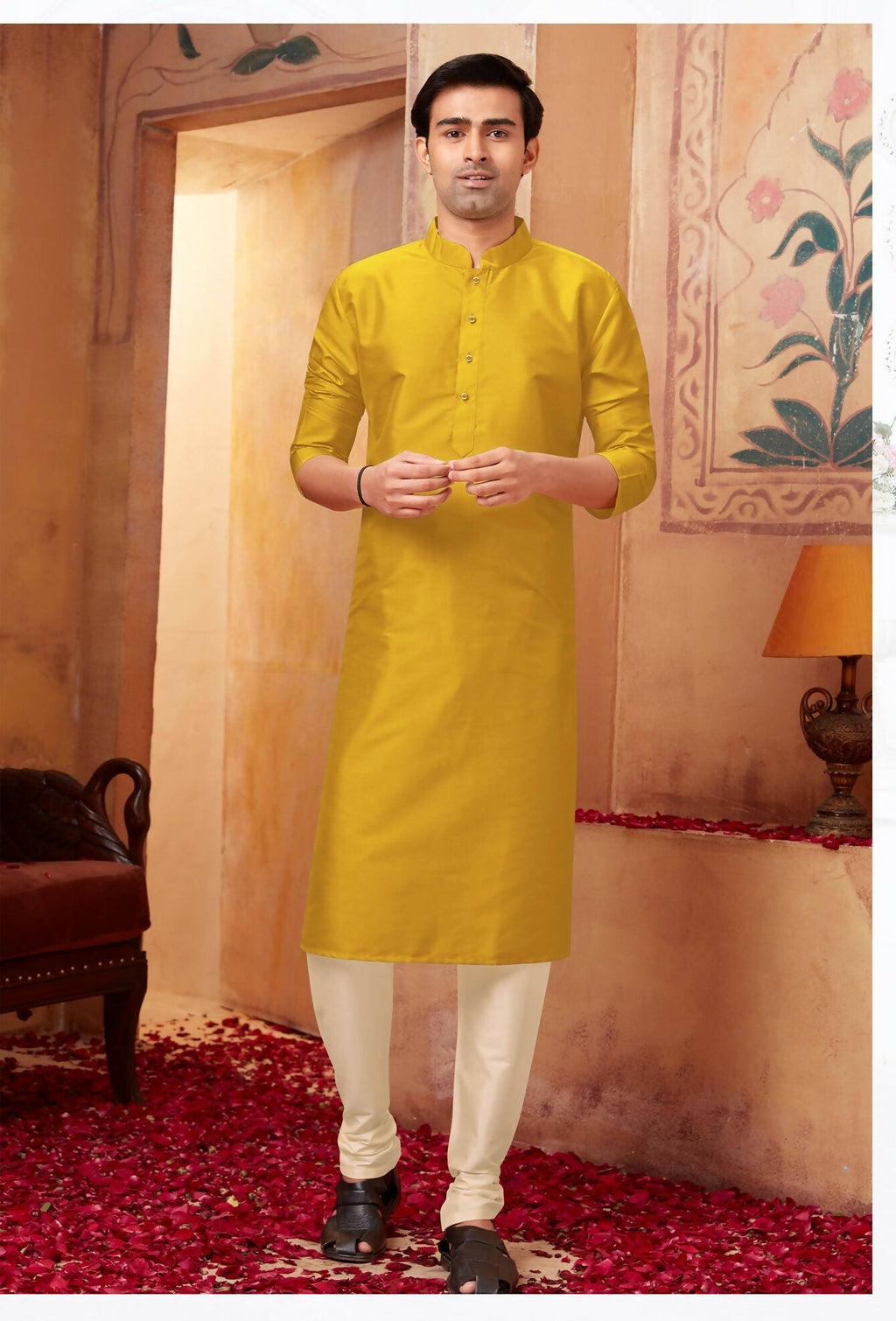 Little boy wearing a traditional green art silk kurta with off-white pyjama bottoms