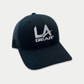 Front view of black classic trucker hat with embroidered LA Gear logo and mesh back panels.
